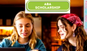 Law student reviewing ABA scholarships applications for the 2025/2026 academic year with books and documents on a desk.